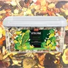 A clear plastic container filled with bird food, featuring a label with a parrot illustration and product details. Náhled obrázku produktu