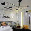 A modern living room with a sectional sofa, coffee table, and a unique chandelier. Anteprima dell’immagine prodotto