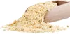 A wooden scoop filled with peanut butter powder, with some powder spilled onto a white surface. Produktbild-Vorschau