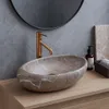 A close-up shot of a stone countertop with a sink and faucet. Anteprima dell’immagine prodotto