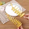 A close-up shot of spiral-cut potatoes on skewers, with hands holding the skewers, on a table with a checkered cloth and some lemon slices. Náhled obrázku produktu