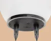 Close-up view of the bottom of a white solar garden light, showing the black base with two stakes. Produktbild-Vorschau