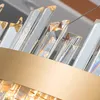 A close-up view of a gold-colored metal band with many clear, faceted crystal elements extending upwards from it. Produktbild-Vorschau