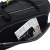 A magazine is placed inside an open black travel bag. Voir les images du produit