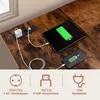 A close-up view of a desk with a tablet and smartphone charging, along with integrated power outlets and USB ports. Produktbild-Vorschau