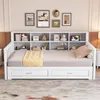 A white daybed with a built-in bookshelf, drawers, and a mattress is shown in a room. Náhled obrázku produktu