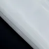 A close-up view of a white fabric with a black background. Produktbild-Vorschau