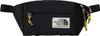 A black fanny pack with a white label and gold accents. Produktbild-Vorschau