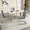 A dining set with a marble-top table and four chairs with gold legs is arranged on a light gray rug in a modern dining room. Podgląd zdjęcia produktu