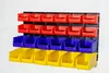 A wall-mounted storage system with multiple bins in red, blue, and yellow. Produktbild-Vorschau