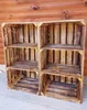 Two wooden crates with shelves are shown against a wooden wall. Náhled obrázku produktu