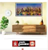 A living room scene with a wooden media console, a plant, a clock, and a framed picture of a city skyline. Anteprima dell’immagine prodotto