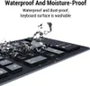 A close-up of a black keyboard with water splashing on it, highlighting its waterproof feature. Produktbild-Vorschau