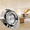 A close-up of a recessed LED spotlight in a modern living room with a dining area and staircase in the background. Produktbild-Vorschau