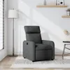 A dark gray fabric recliner chair is shown in a well-lit room with a floor lamp and a small side table. Produktbild-Vorschau