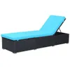 A black rattan sun lounger with a bright blue cushion, shown against a white background. Náhľad obrázku produktu