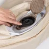 A hand is pressing a switch on an air pump mechanism that is part of a beige sofa. Produktbild-Vorschau