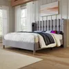 A bedroom scene featuring a gray upholstered bed with white bedding and a blue and gray throw blanket. Produktbild-Vorschau