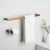 A bathroom setting with copper-colored towel and toilet paper holders mounted on a white wall. Produktbild-Vorschau