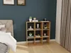 A bedroom with a bed, a dark blue wall, and a wooden cube shelf filled with decorative items. Náhľad obrázku produktu