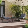 A patio scene with two chairs and a table under an umbrella. Produktbild-Vorschau
