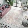 A modern living room with a pink sofa, a rug, and plants. Anteprima dell’immagine prodotto
