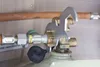 A close-up view of a gas cylinder connection with a multi-functional wrench attached. Produktbild-Vorschau