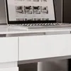 A close-up view of a white desk with a laptop on it. Produktbild-Vorschau