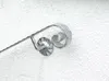 A close-up view of a metal handrail component with a scroll design, mounted on a textured wall. Anteprima dell’immagine prodotto