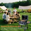 A group of people are enjoying a barbecue in a park setting with tents in the background. Anteprima dell’immagine prodotto