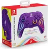 The image shows the retail packaging of a purple Nintendo Switch controller with colorful wave-like designs and text describing its features. Produktbild-Vorschau