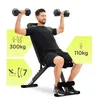 A man is sitting on a weight bench and lifting dumbbells. Podgląd zdjęcia produktu