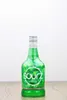 A bottle of Sourz Apple liqueur is placed on a wooden surface against a white background. Produktbild-Vorschau