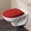 A white wall-mounted toilet with a red toilet seat is shown in a bathroom setting. Anteprima dell’immagine prodotto