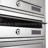 A close-up view of a multi-unit stainless steel mailbox system. Produktbild-Vorschau