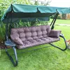 A garden swing with brown cushions and a green canopy, set on a green lawn. Náhled obrázku produktu