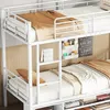 A close-up view of a white metal bunk bed with bedding and decorative items. Anteprima dell’immagine prodotto