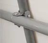 Close-up of a metal joint connecting two gray pipes, likely part of a greenhouse frame. Voir les images du produit