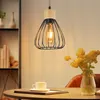 A pendant light hangs above a table set with a cup of coffee and a vase of flowers. Anteprima dell’immagine prodotto