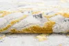 A close-up, angled view of a rolled-up rug with a textured pattern. Produktbild-Vorschau