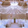 A beautifully decorated indoor venue, likely for a wedding or event, with tables set and fairy lights strung across the ceiling. Náhled obrázku produktu