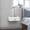 A white floating nightstand with a drawer next to a bed with a polka dot pillow. Produktbild-Vorschau