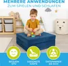 A young boy is playing with building blocks on a blue foldable mattress in a child's room. Produktbild-Vorschau