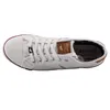 A top-down view of a white canvas sneaker with brown accents. Produktbild-Vorschau