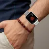 A person's arm wearing a smartwatch and a bracelet. Náhled obrázku produktu