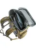 An open backpack with items inside, viewed from above. Voir les images du produit