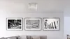 A ceiling light fixture is shown above three framed black and white photographs hanging on a white wall above a sofa. Produktbild-Vorschau