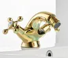 A close-up studio shot of a gold-colored faucet, likely for a sink or bidet, placed on a white surface. Anteprima dell’immagine prodotto
