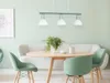 A dining area with a round wooden table, green chairs, and a sofa. Produktbild-Vorschau