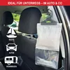 A moisture absorber bag hanging from the headrest of a car seat, with icons of a sailboat, car, and caravan on the left side. Produktbild-Vorschau